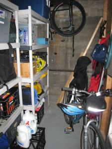 organized shelvs filled with sporting gears, room for bike and walk through